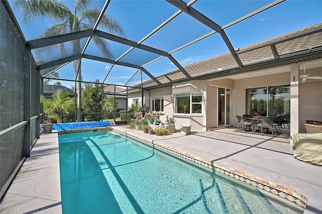 view of swimming pool with a patio area, ceiling fan, and a lanai