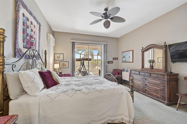 bedroom featuring a textured ceiling, access to outside, ceiling fan, and carpet floors