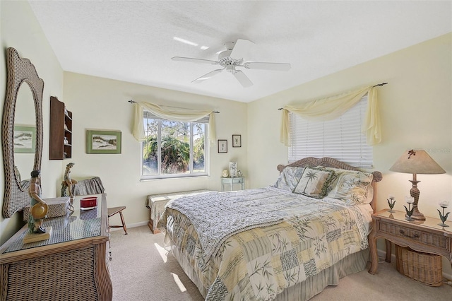 bedroom with ceiling fan and light colored carpet