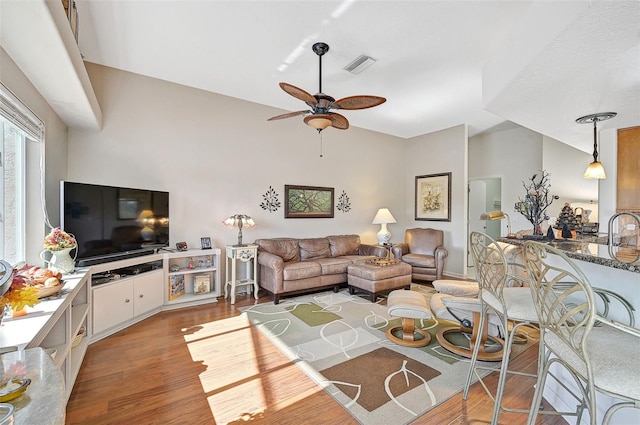 living room with ceiling fan, sink, and light hardwood / wood-style flooring