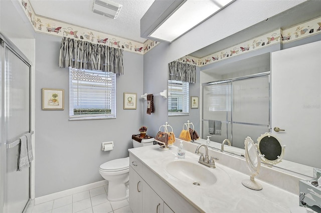 bathroom with tile patterned floors, a textured ceiling, toilet, vanity, and a shower with shower door