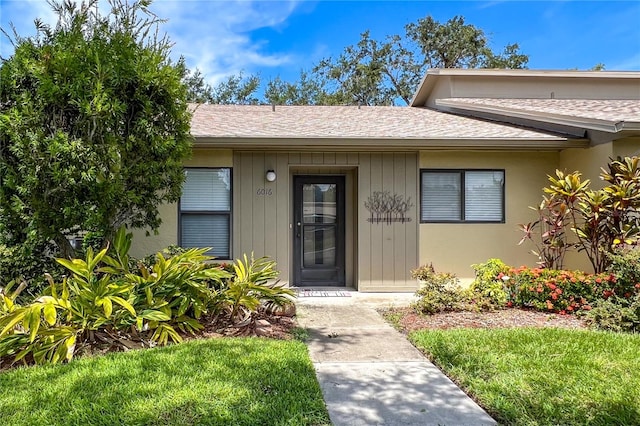 doorway to property with a yard