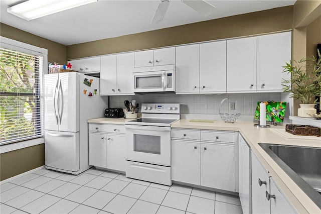 kitchen with ceiling fan, white cabinets, backsplash, white appliances, and light tile patterned floors