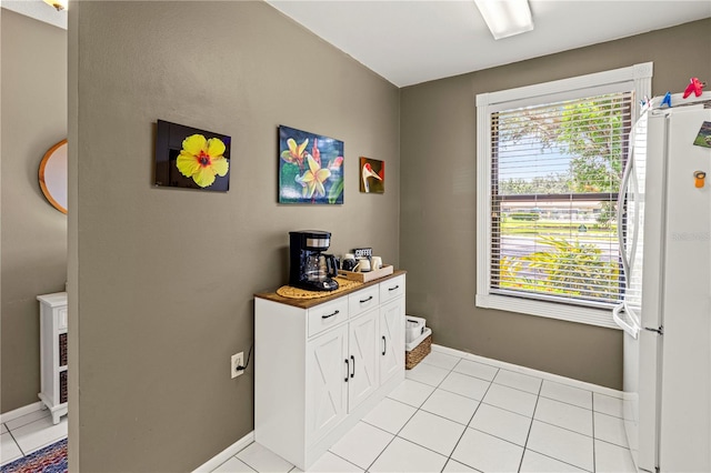 interior space with light tile patterned floors and plenty of natural light