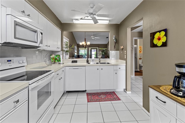 kitchen featuring white cabinets, pendant lighting, light tile patterned flooring, and white appliances