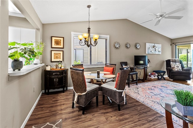 dining space with ceiling fan with notable chandelier, dark hardwood / wood-style floors, and lofted ceiling