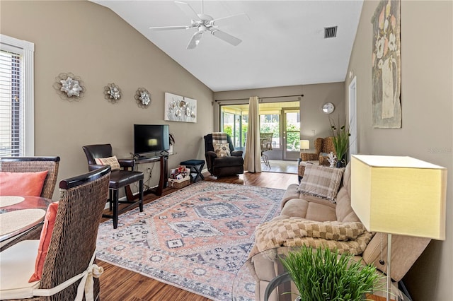 living room with hardwood / wood-style flooring, plenty of natural light, and lofted ceiling