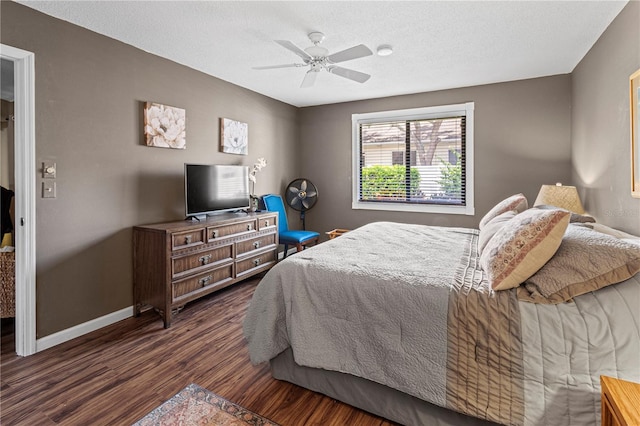 bedroom featuring a textured ceiling, dark hardwood / wood-style flooring, and ceiling fan