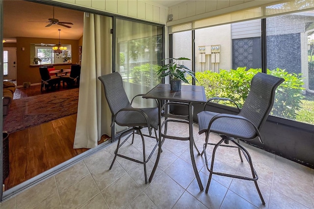 sunroom / solarium featuring ceiling fan and vaulted ceiling