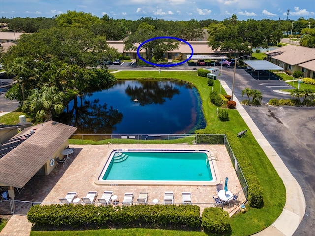 view of swimming pool with a water view