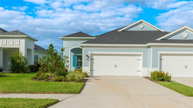 view of front of property featuring a garage and a front yard