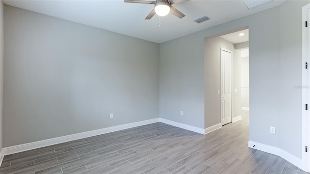 unfurnished room with ceiling fan and hardwood / wood-style flooring