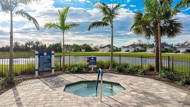 view of pool featuring a community hot tub and a water view