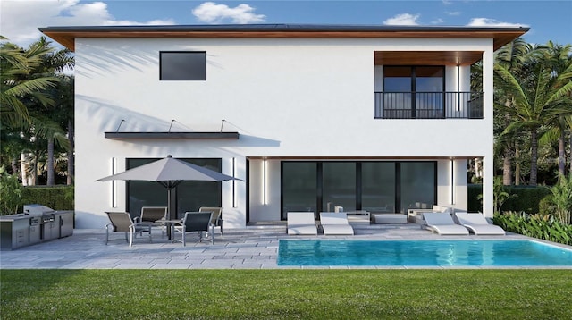 back of house with a yard, a patio, a balcony, and exterior kitchen