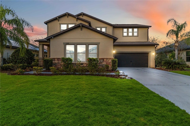 view of front of home with a lawn and a garage