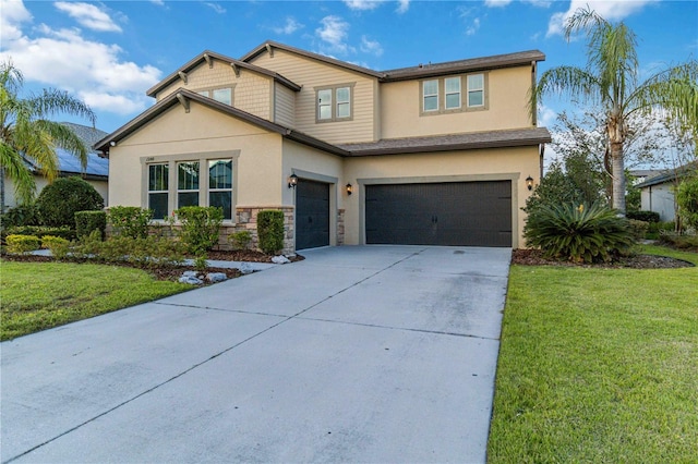 view of front of property featuring a garage and a front yard