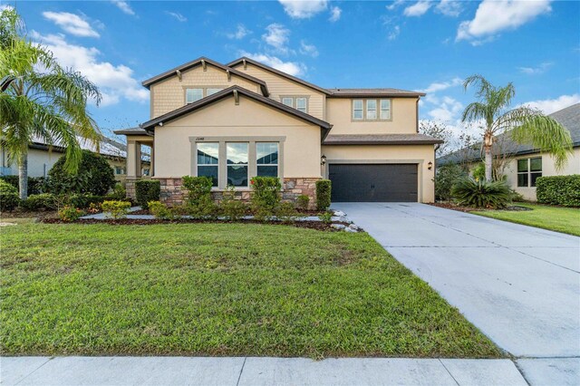 13148 Bliss Loop, Bradenton, FL 34211 - view of front of home with driveway, a garage, stone siding, stucco siding, and a front yard