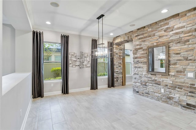 unfurnished room featuring crown molding and a notable chandelier