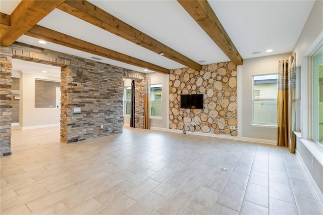 unfurnished living room with beam ceiling and a fireplace