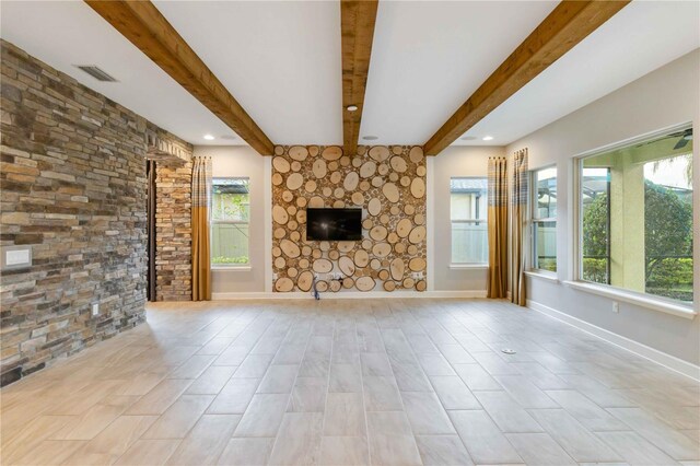 13148 Bliss Loop, Bradenton, FL 34211 - unfurnished living room with beamed ceiling, a fireplace, baseboards, and recessed lighting