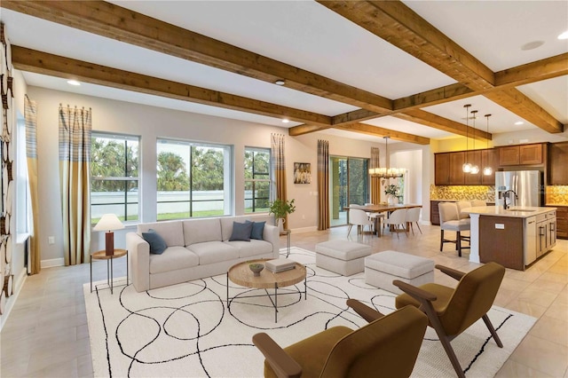 tiled living room featuring beam ceiling, a notable chandelier, and sink