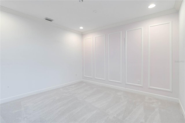 empty room featuring light colored carpet and ornamental molding