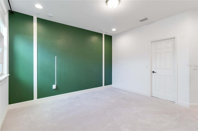 spare room featuring light colored carpet