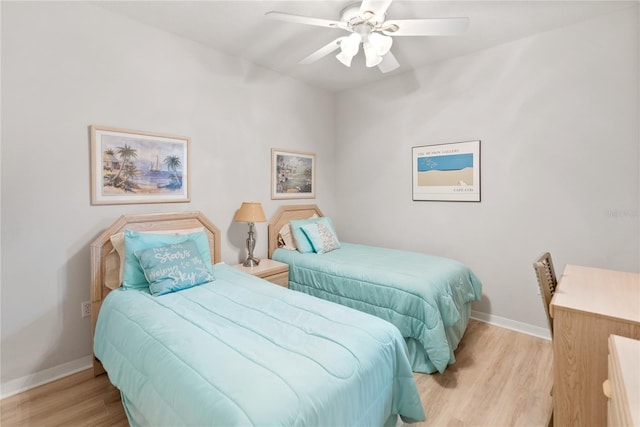 bedroom with light hardwood / wood-style flooring and ceiling fan