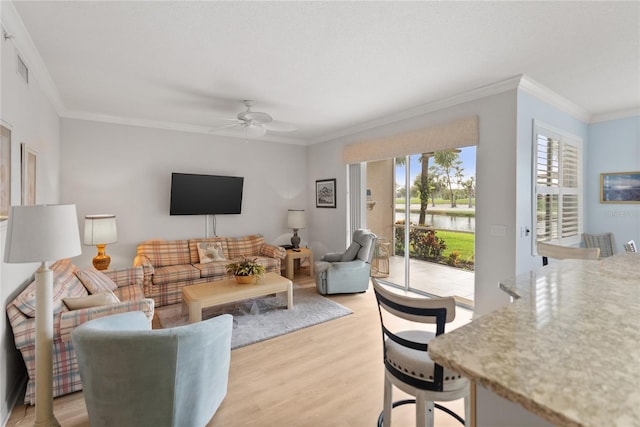 living room featuring crown molding, light hardwood / wood-style flooring, and ceiling fan