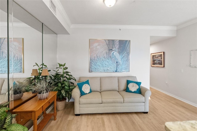 living room with light hardwood / wood-style flooring and ornamental molding