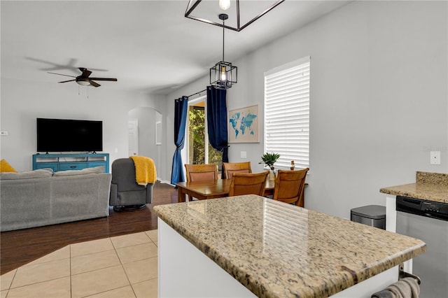 tiled dining area with ceiling fan