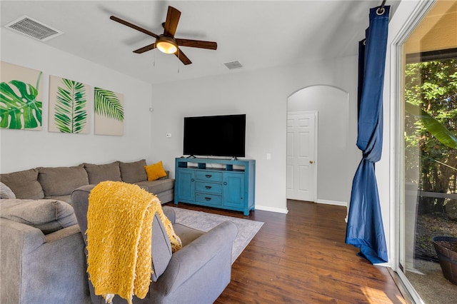 living room featuring dark hardwood / wood-style floors and ceiling fan