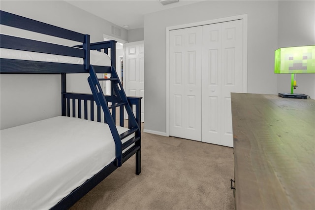 bedroom with light colored carpet and a closet