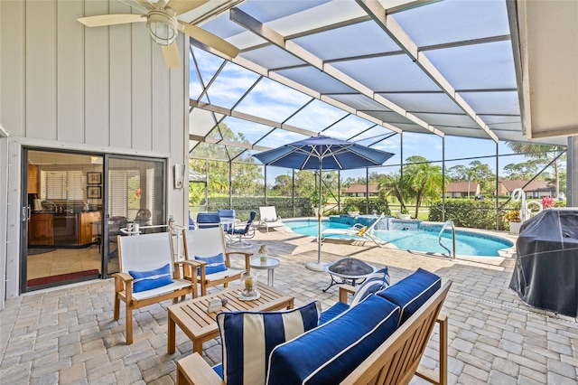 view of patio / terrace featuring pool water feature, a fire pit, a lanai, and a grill