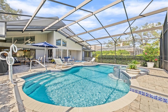 view of swimming pool featuring glass enclosure and a patio