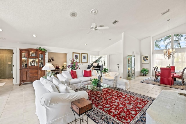 living room featuring a textured ceiling, ceiling fan with notable chandelier, high vaulted ceiling, and light tile patterned flooring