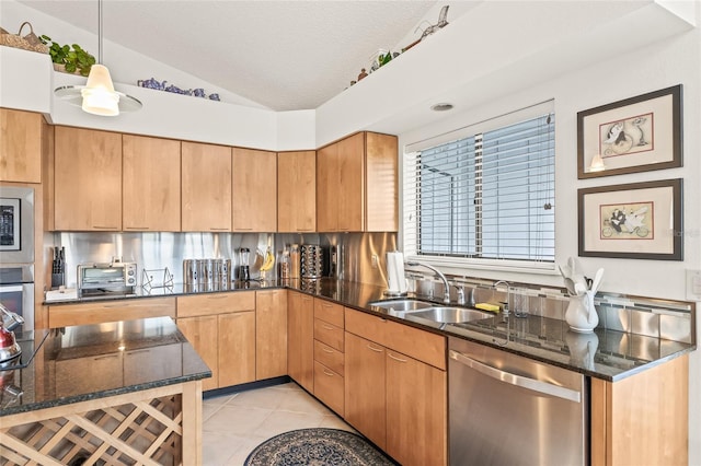 kitchen with appliances with stainless steel finishes, a textured ceiling, vaulted ceiling, pendant lighting, and light tile patterned flooring