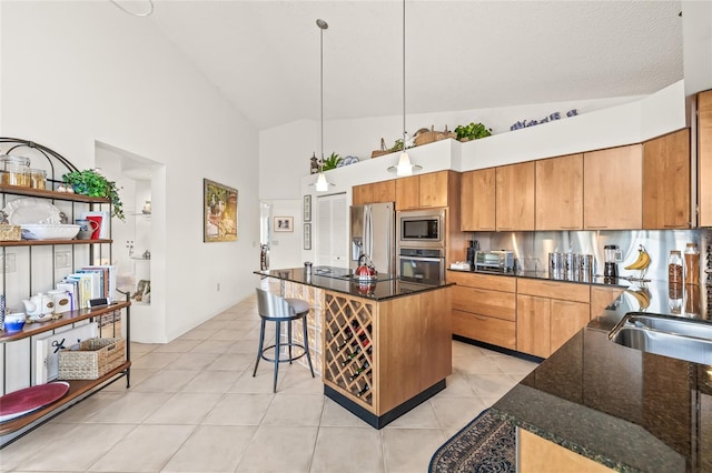 kitchen featuring a breakfast bar, a center island, decorative light fixtures, light tile patterned flooring, and stainless steel appliances