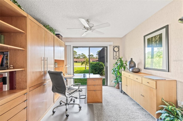 office with ceiling fan, a textured ceiling, and light carpet