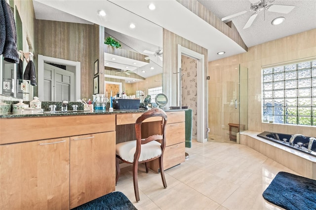 bathroom featuring tile patterned flooring, vanity, separate shower and tub, and a textured ceiling