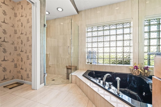 bathroom featuring tile patterned floors, a healthy amount of sunlight, a textured ceiling, and independent shower and bath