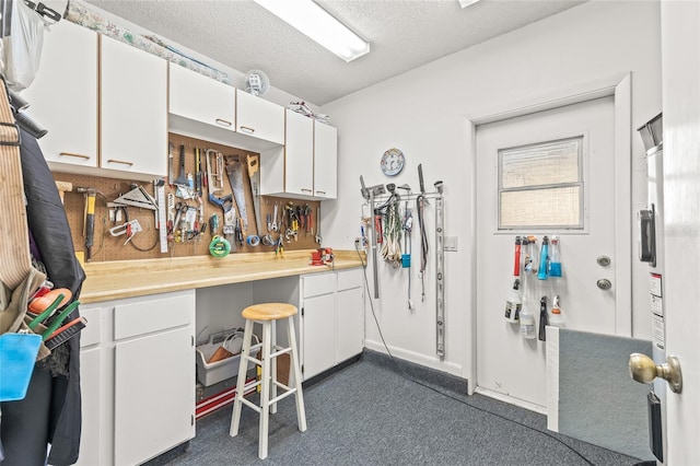 kitchen featuring white cabinets and a textured ceiling