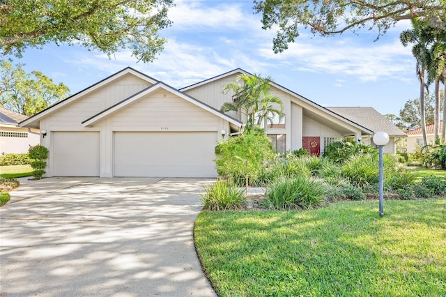 view of front of home with a garage and a front lawn