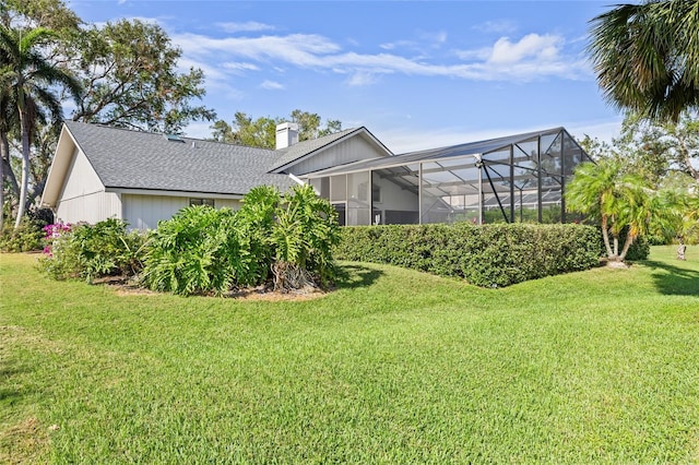 exterior space with a lawn and glass enclosure