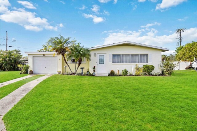 2057 Garden Pkwy, Bradenton, FL 34205 - ranch-style home featuring driveway, a front yard, stucco siding, and an attached garage