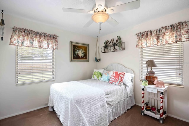 carpeted bedroom featuring multiple windows and ceiling fan