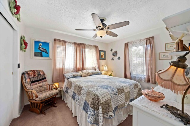 2057 Garden Pkwy, Bradenton, FL 34205 - bedroom with a closet, light carpet, a textured ceiling, and a ceiling fan
