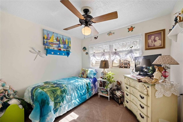 bedroom featuring carpet flooring, ceiling fan, and a textured ceiling