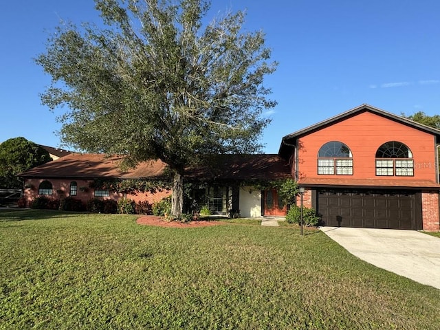 view of front of home with a front yard and a garage