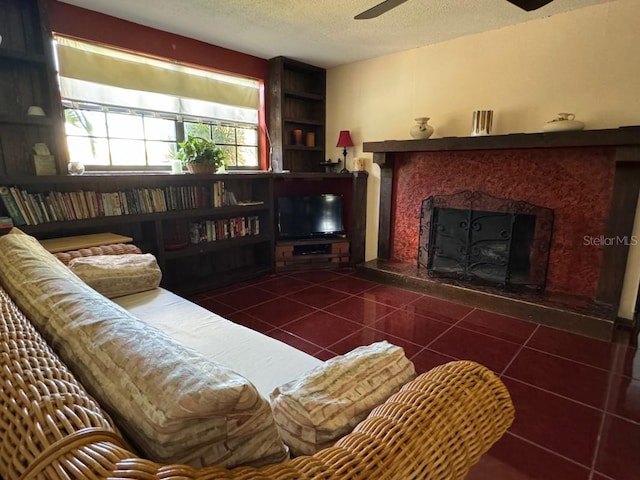 tiled living room featuring a fireplace, a textured ceiling, and ceiling fan